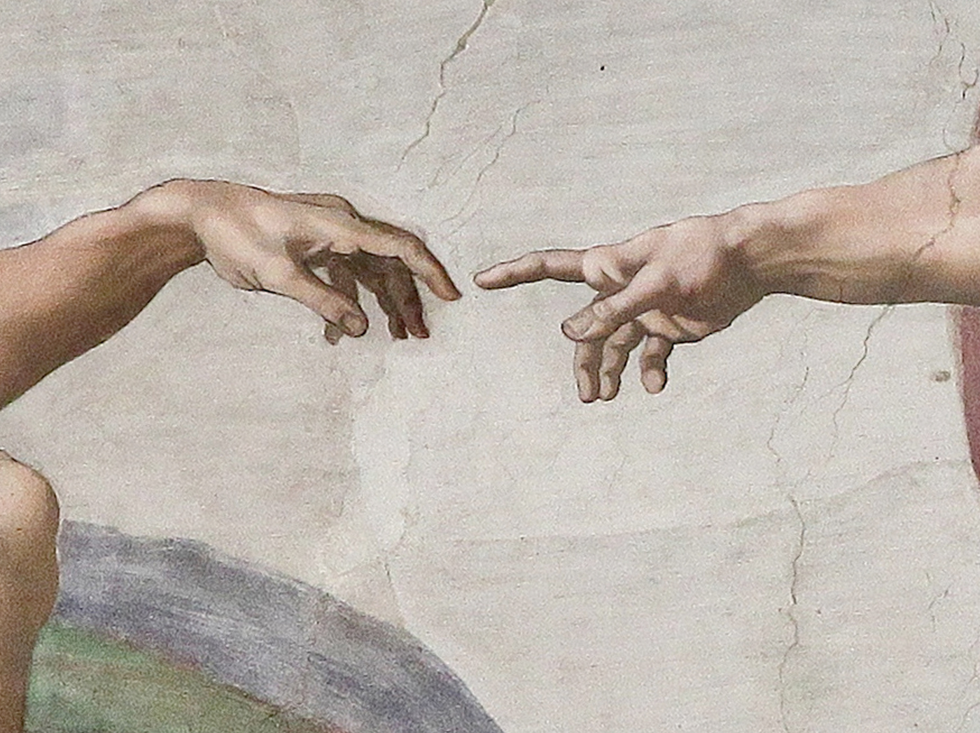 Detail of the almost-touching hands of God and Adam in Michelangelo’s Creation of Adam
